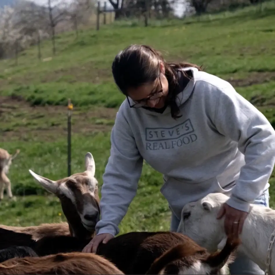 Woman petting goats